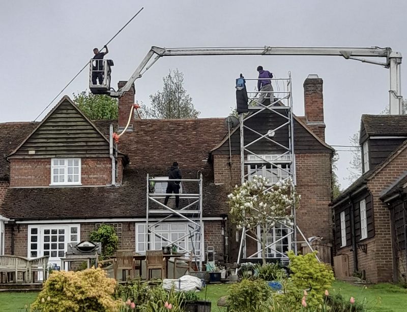The Moss Cleaners using cherry picker and scaffolding to clean roof safely and professionally in Chislehurst, {{COUNTY}}